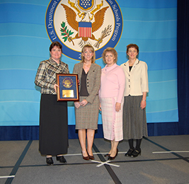 Staff members pose with Blue Ribbon Plaque